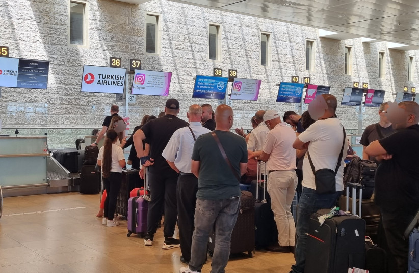  Israelis stand in line for a flight to Istanbul, at Ben-Gurion International Airport, outside of Tel Aviv, June 15, 2022. (credit: MAYA MARGIT/THE MEDIA LINE)
