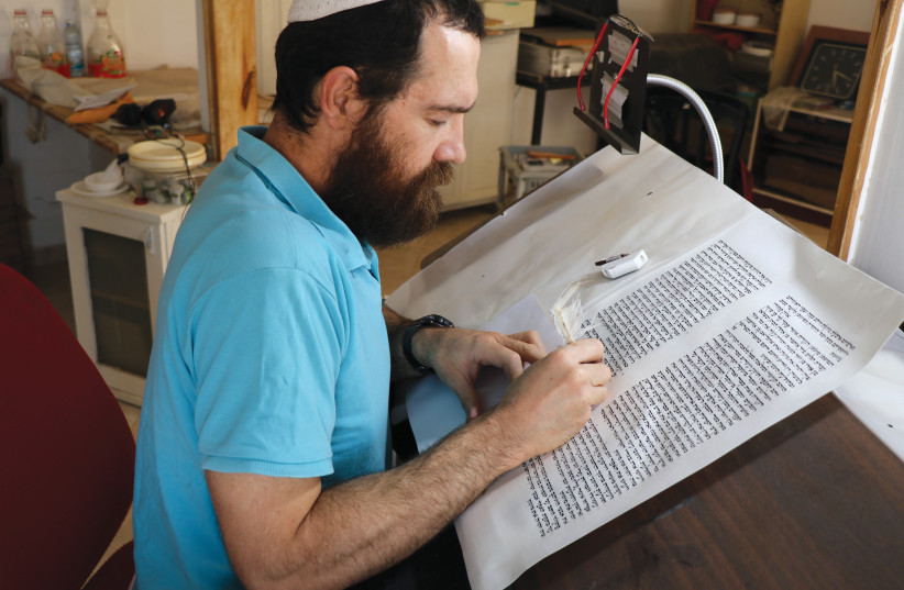  Neriah Israel writing a page of a Sefer Torah scroll. (photo credit: NERIAH ISRAEL)