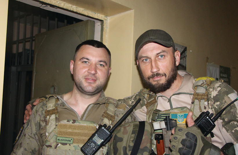  TWO UKRAINIAN soldiers, in the basement of a police station during a shelling, Lysychansk, last week. (credit: JONATHAN SPYER)