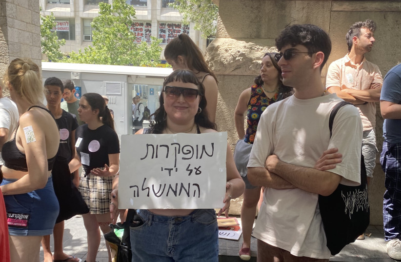  A participant at the Jerusalem SlutWalk holding a sign reading ''abandoned at the hands of the government,'' June 17, 2022 (credit: Shira Silkoff)