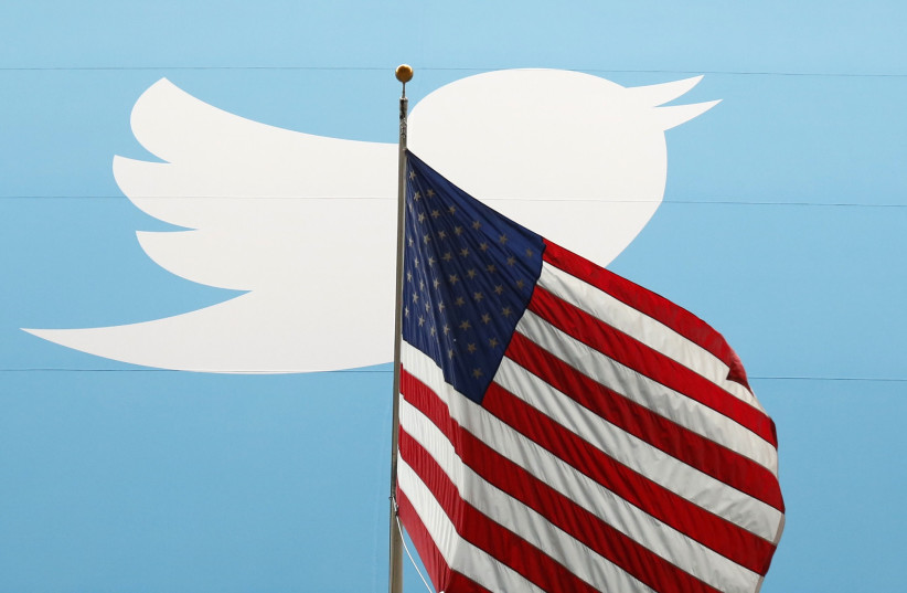  The Twitter Inc. logo is shown with the US flag  (credit: LUCAS JACKSON/REUTERS)