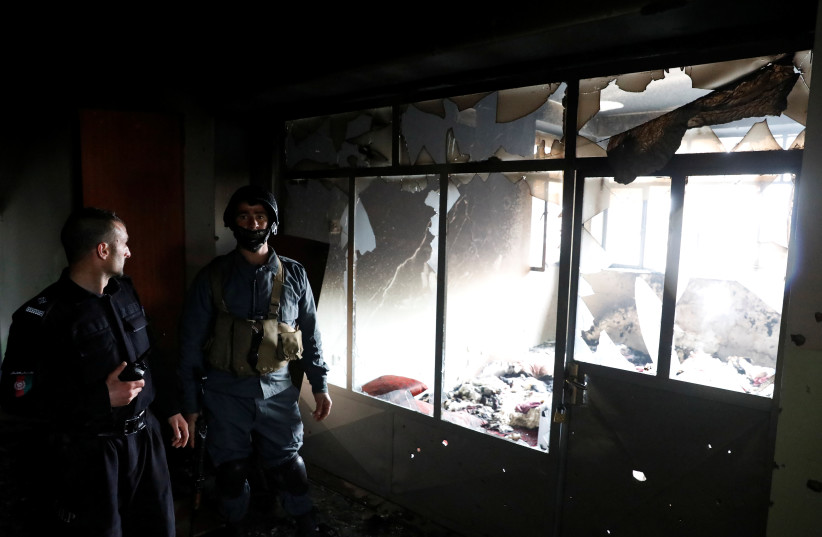  Afghan policemen inspect inside a Sikh religious complex after an attack in Kabul, Afghanistan March 25, 2020 (credit: REUTERS/MOHAMMAD ISMAIL)