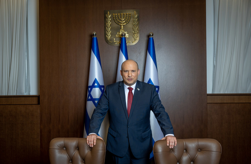  Israeli Prime Minister Naftali Bennett poses for a picture at the Prime Minister's office in Jerusalem, January 26, 2022. (credit: YONATAN SINDEL/FLASH90)