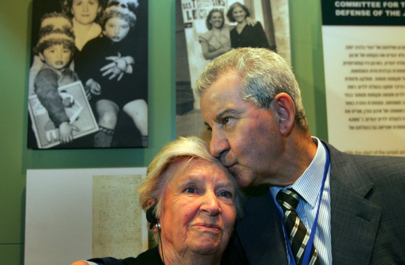  Andrée Geulen-Herscovici, a Belgian woman who rescued some 300 Jewish children from the Nazis during the Holocaust, is embraced by Henri Lederhandler, one of the children she rescued, in front of the exhibit on her efforts in the museum of the Yad Vashem Holocaust Memorial in Jerusalem, April 18, 2 (photo credit: DAVID SILVERMAN/GETTY IMAGES VIA JTA)