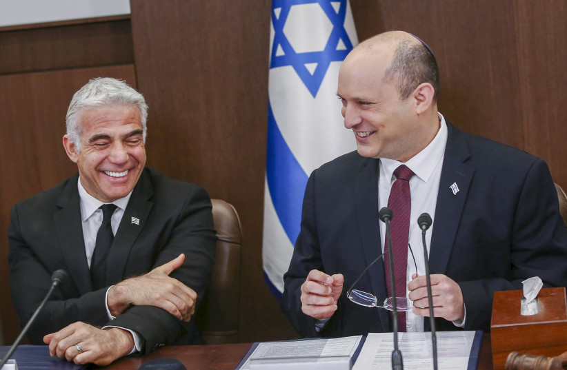  Israeli Prime Minister Naftali Bennett and Foreign Minister Yair Lapid seen at a cabinet meeting at the Prime Minister's Office in Jerusalem on June 19, 2022.  (photo credit: ALEX KOLOMOISKY/FLASH90)