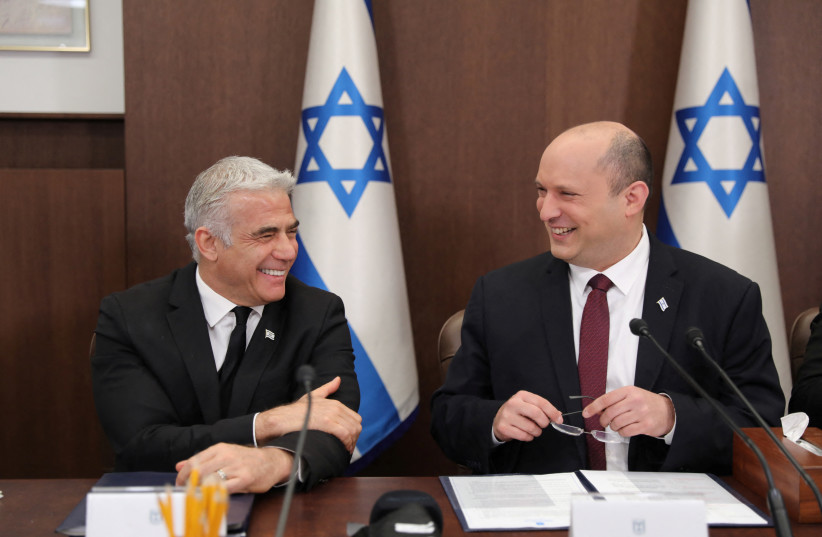  Israeli Prime Minister Naftali Bennett and foreign minister Yair Lapid attend a cabinet meeting at the Prime minister's office in Jerusalem, Israel, June 19 2022.  (photo credit: ABIR SULTAN/POOL/VIA REUTERS)