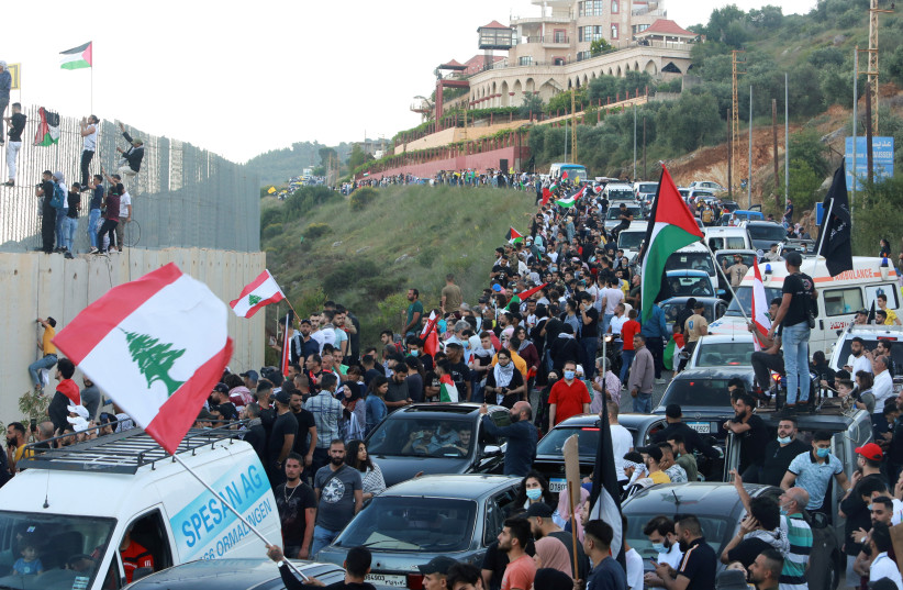  Demonstrators gather during a protest to express solidarity with the Palestinian people, in Adaisseh village near the Lebanese-Israeli border, southern Lebanon May 15, 2021. (credit: AZIZ TAHER/REUTERS)