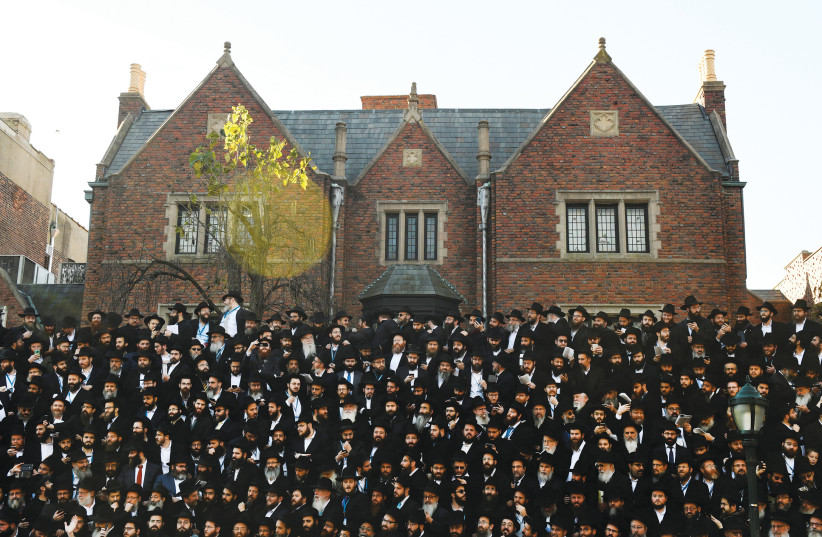  RABBIS POSE in front of Chabad Lubavitch World Headquarters in Brooklyn, in 2018. After the writer returned to New York for rabbinical ordination, a rabbi from Sydney asked him if he was ready to date.  (photo credit: MARK KAUZLARICH/REUTERS)