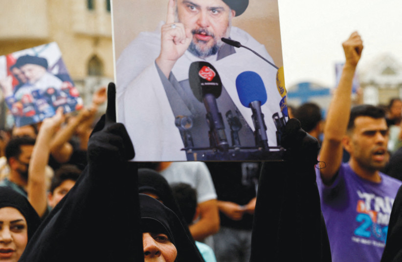  SUPPORTERS OF Iraqi Shi’ite Muslim cleric Muqtada al-Sadr shout slogans during a celebration after Iraq’s parliament passed a law criminalizing normalizing relations with Israel, in Baghdad last month. (photo credit: THAIER AL-SUDANI/REUTERS)