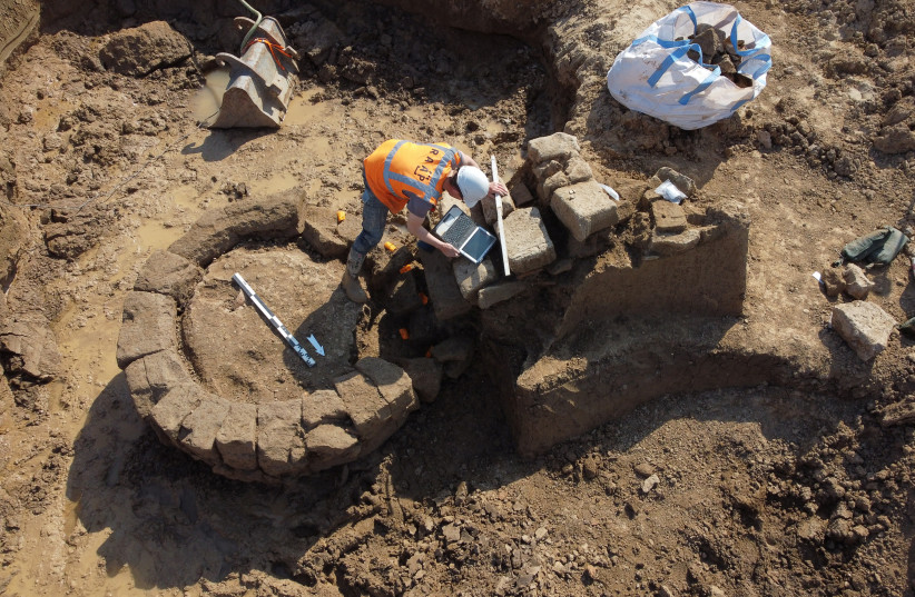  A person works on a site where archaeologists discovered a Roman temple in Zevenaar, central-east Netherlands May 4, 2022. Picture taken May 4, 2022. (credit: RAAP/Handout via REUTERS)