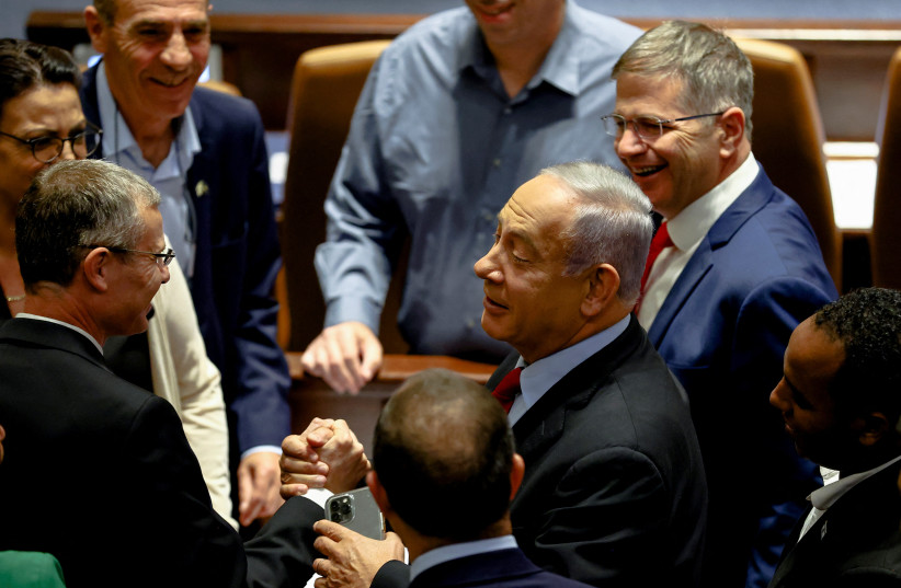 Benjamin Netanyahu is surrounded by Likud members at a preliminary reading at the Knesset of a bill to dissolve the parliament after Prime Minister Naftali Bennett and Foreign Minister Yair Lapid moved to disband their government and hold an election, in Jerusalem, June 22, 2022. (photo credit: RONEN ZVULUN/REUTERS)