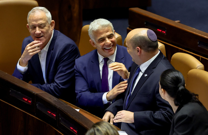  Israeli Defense Minister Benny Gantz, Foreign Minister Yair Lapid and Prime Minister Naftali Bennett attend a preliminary reading of a bill to dissolve the Knesset, in Jerusalem, June 22, 2022. (credit: RONEN ZVULUN/REUTERS)