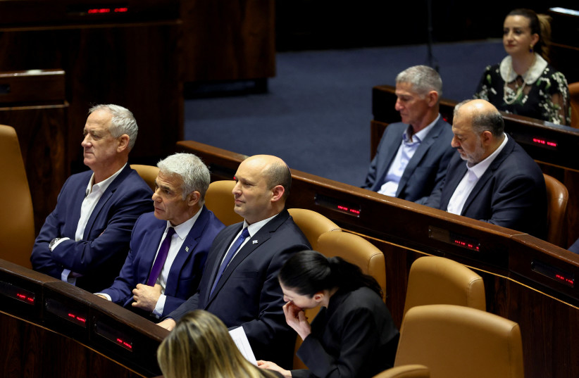  Israeli Defense Minister Benny Gantz, Foreign Minister Yair Lapid and Prime Minister Naftali Bennett attend a preliminary reading of a bill to dissolve the Knesset, in Jerusalem, June 22, 2022. (photo credit: RONEN ZVULUN/REUTERS)