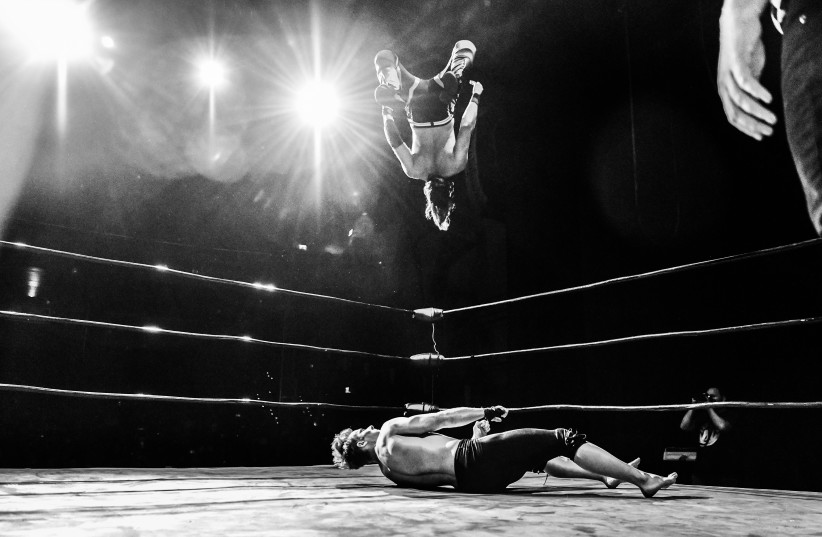 Israeli wrestler Yuval Goldshmit sets up the shooting star press on Cara Noir. (photo credit: Max Stranger)