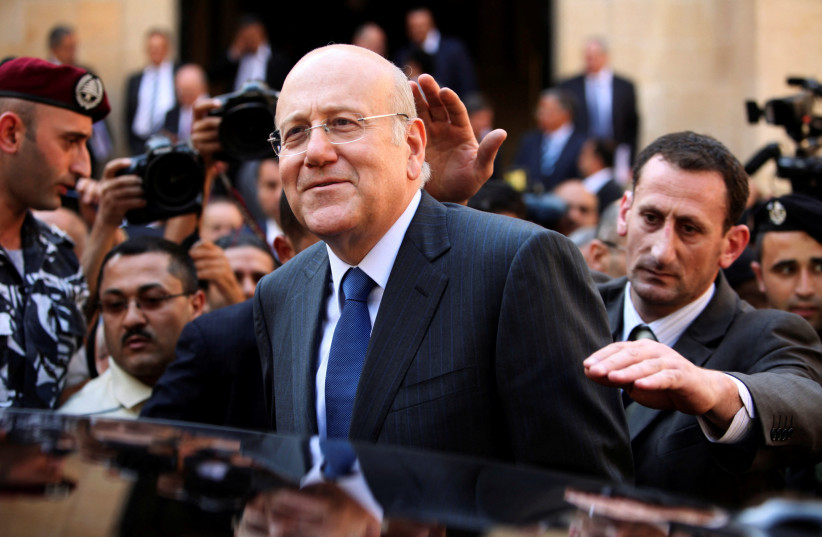 Lebanon's Prime Minister Najib Mikati leaves the parliament building under the escort of body guards, after winning 68 out of 128 votes in a vote of confidence on the third day of the parliamentary session in Beirut, Lebanon, July 7, 2011. (credit: REUTERS/MOHAMED AZAKIR/FILE PHOTO)