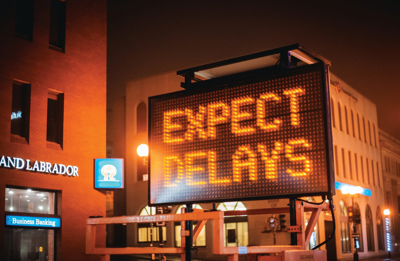  Sign indicates one should expect delays. Jerusalem suffers severe traffic and its public transport system leaves much to be desired (Illustrative). (credit: ERIK MCLEAN/UNSPLASH)