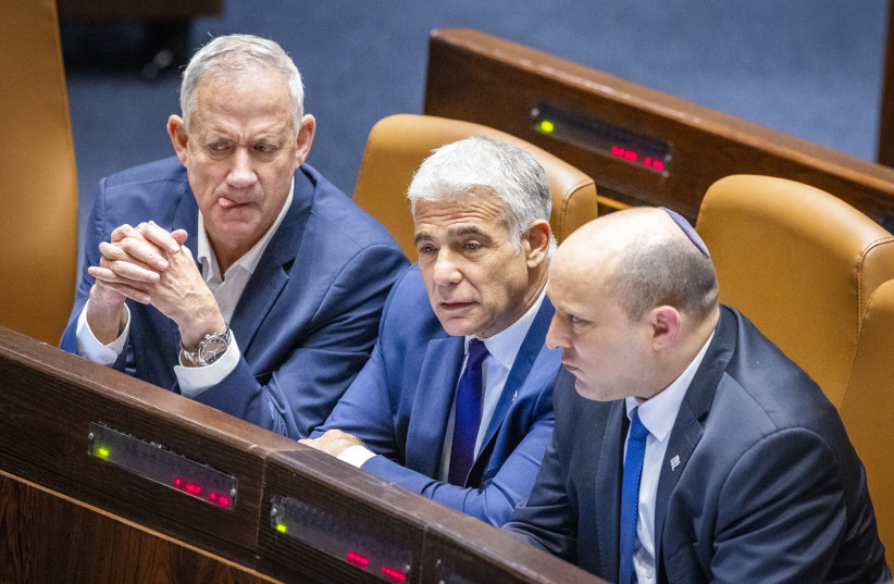  Israeli prime minister Naftali Bennett, Minister of Defense Benny Gantz and Minister of Foreign Affairs Yair Lapid during a discussion and a vote on a bill to dissolve the Knesset, at the assembly hall of the Israeli parliament, in Jerusalem, on June 22, 2022. (credit: OLIVIER FITOUSSI/FLASH90)
