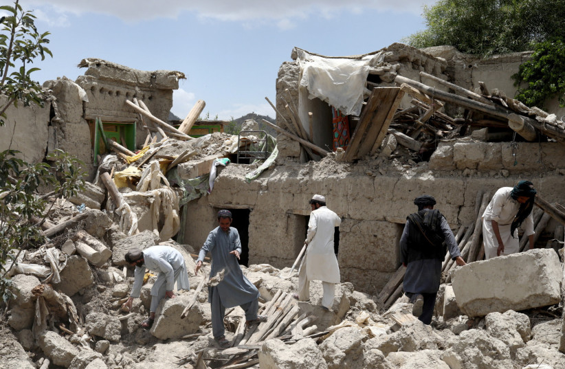 Afghan men search for survivors amidst the debris of a house that was destroyed by an earthquake in Gayan, Afghanistan, June 23, 2022. (photo credit:  REUTERS/ALI KHARA)