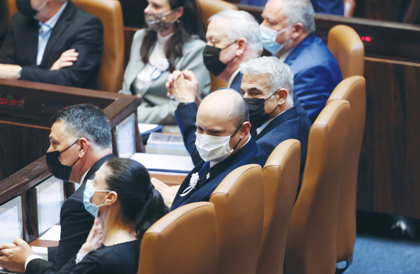 PRIME MINISTER Naftali Bennett and his government attend their inauguration ceremony at the Knesset in July 2021. (photo credit: RONEN ZVULUN/REUTERS)