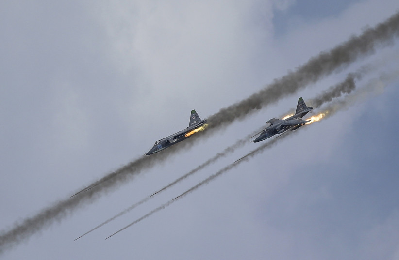  Russian Sukhoi Su-25 Frogfoot ground-attack planes perform during the Aviadarts military aviation competition at the Dubrovichi range near Ryazan, Russia, August 2, 2015 (Illustrative). (photo credit: MAXIM SHEMETOV/REUTERS)