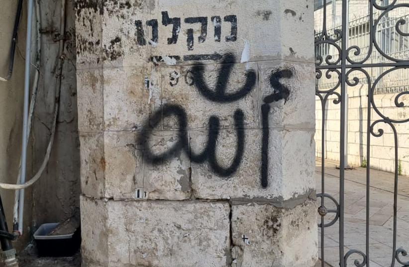  Arabic graffiti sprayed on a synagogue and church in Ramle. (credit: ISRAEL POLICE)
