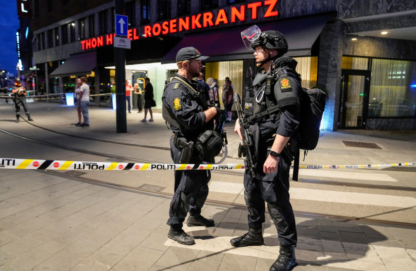  Security forces stand at the site where two people were killed during a shooting outside the London pub in central Oslo, Norway (photo credit: REUTERS)