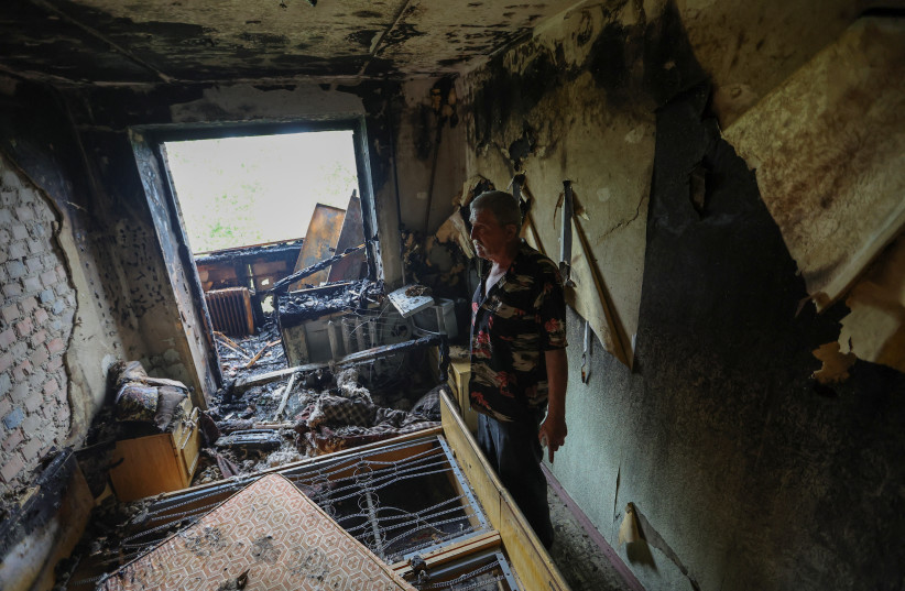  Local resident Gennady Goncharov, 67, estimates the damage of his apartment following previous night's shelling in the course of Ukraine-Russia conflict in Donetsk, Ukraine (photo credit: REUTERS/ALEXANDER ERMOCHENKO)