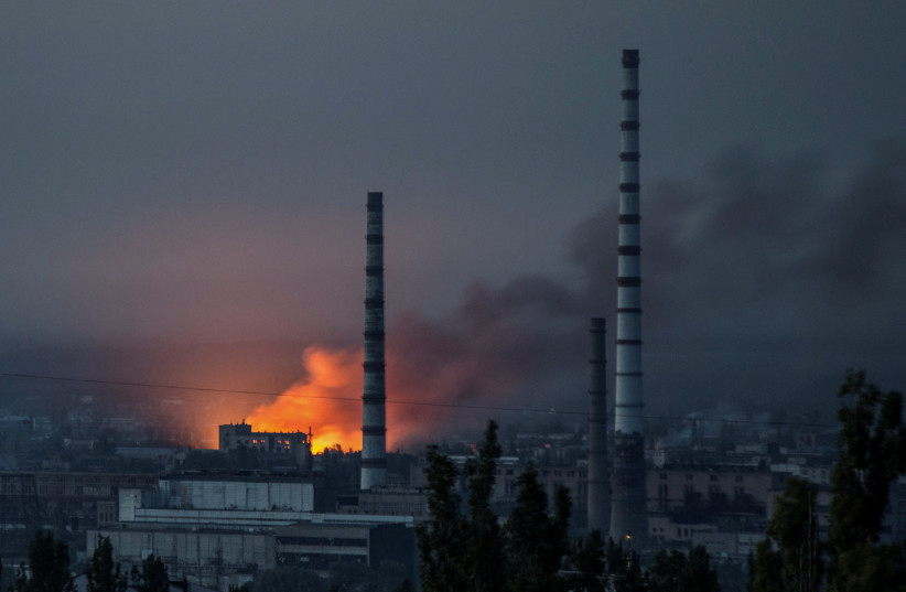Smoke and flame rise after a military strike on a compound of Sievierodonetsk's Azot Chemical Plant, as Russia's attack on Ukraine continues, in Lysychansk, Luhansk region, Ukraine, June 18, 2022. (credit: REUTERS/OLEKSANDR RATUSHNIAK)