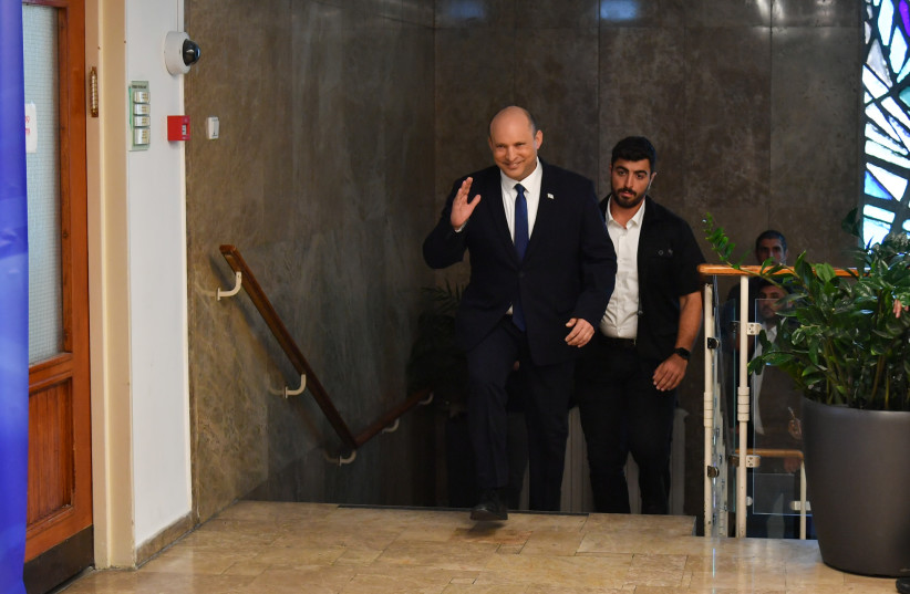  Israeli Prime Minister Naftali Bennett arrives at a cabinet meeting before the first reading of the bill to disperse the Knesset, June 26, 2022. (credit: YOAV DUDKEVITCH)
