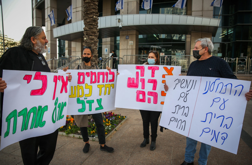  Activists protest for better financial support to former South Lebanon Army (SLA) warriors, outside the Defense Ministry offices in Tel Aviv on March 9, 2021 (photo credit: FLASH90)