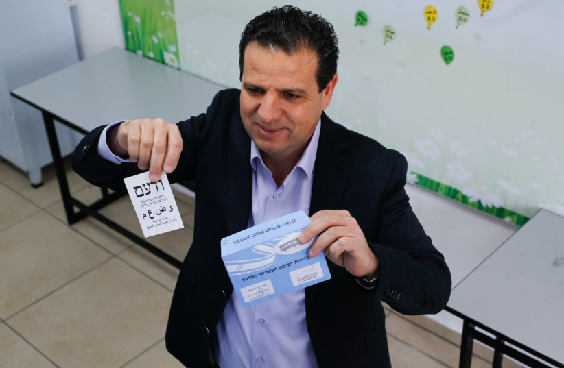  Head of the Joint List Ayman Odeh casts his vote at a polling station in the general elections, on March 23, 2021 (credit: JAMAL AWAD/FLASH90)