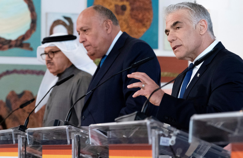 Israel's Foreign Minister Yair Lapid speaks next to Bahrain's Foreign Minister Abdullatif bin Rashid al-Zayani, and Egypt's Foreign Minister Sameh Shoukry during remarks at the Negev Summit, in Sde Boker, Israel March 28, 2022. (photo credit: Jacquelyn Martin/Pool via REUTERS)