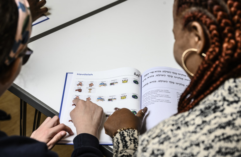  New Siddur Lakol being used by Kisharon Noe pupil Salome and her Support Worker Necola. (photo credit: ROBERT SHACK)