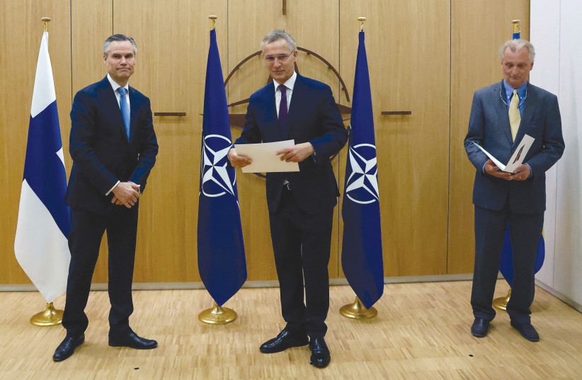  FROM LEFT: Finland’s Ambassador to NATO Klaus Korhonen, NATO Secretary-General Jens Stoltenberg and Sweden’s Ambassador to NATO Axel Wernhoff attend a ceremony to mark the applications for membership of Sweden and Finland, in Brussels, last month. (credit: JOHANNA GERON/REUTERS)