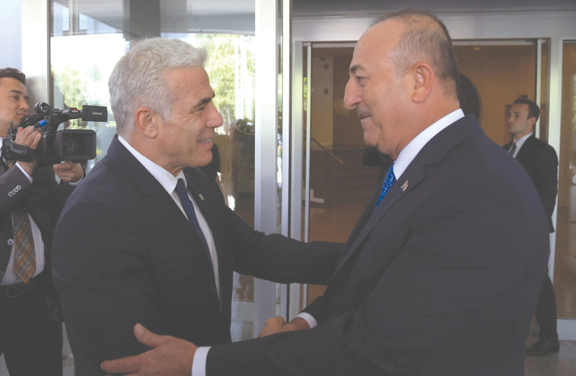  TURKISH FOREIGN MINISTER Mevlut Cavusoglu greets his Israeli counterpart, Yair Lapid, in Ankara, last week.  (photo credit: NECATI SAVAS/REUTERS)