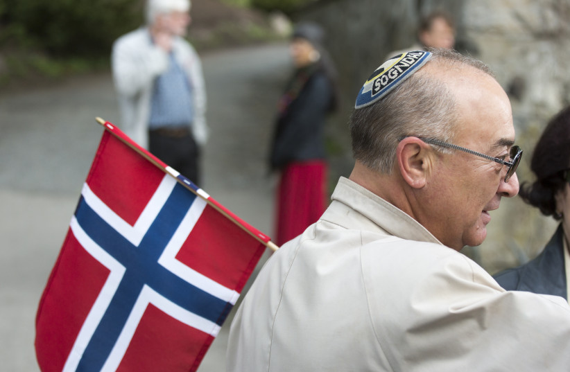  A Jewish man wearing a kippah holds a Norwegian flag on Constitution Day in Oslo. (photo credit: FISHMAN/ULLSTEIN BILD VIA GETTY IMAGES)