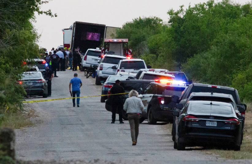  Law enforcement officers work at the scene where people were found dead inside a trailer truck in San Antonio, Texas, US, June 27, 2022. (photo credit: Kaylee Greenlee Beal/Reuters)