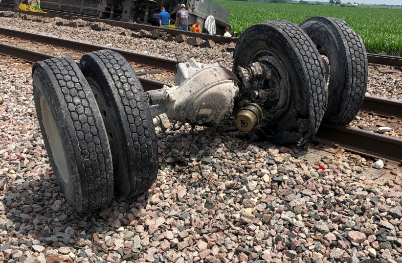  A view of an overturned locomotive following an Amtrak train derailment after it hit a dump truck at an uncontrolled crossing, near Mendon, Missouri, US, June 27, 2022 in this picture obtained from social media. (credit: Dax McDonald/via REUTERS)