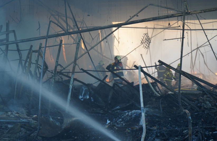  Rescuers work at a site of a shopping mall hit by a Russian missile strike, as Russia's attack on Ukraine continues, in Kremenchuk, in Poltava region, Ukraine, in this handout picture released June 28, 2022. (credit: Press service of the State Emergency Service of Ukraine/Handout via REUTERS)