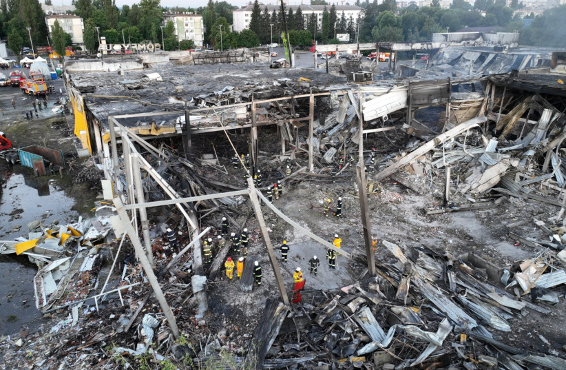  Rescuers work at a site of a shopping mall hit by a Russian missile strike, as Russia's attack on Ukraine continues, in Kremenchuk, in Poltava Oblast, Ukraine, in this handout picture released June 28, 2022. (photo credit: Press service of the State Emergency Service of Ukraine/Handout via REUTERS)