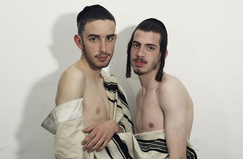   One of the photos, taken by photographer Benyamin Reich, shows two young religious Jewish men, naked, covered only in a tallit (prayer shawl) in order to display homosexuality. (photo credit: BENYAMIN REICH)