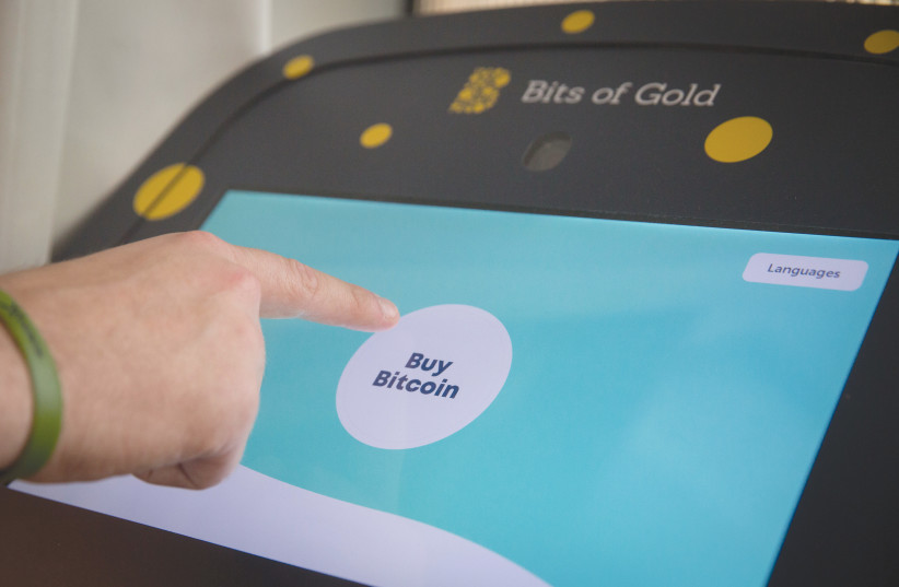  A BITCOIN ATM at the Bitcoin emBassy in Tel Aviv. It is believed that a single Bitcoin transaction uses 707 kWh or more, says the writer (photo credit: MIRIAM ALSTER/FLASH90)