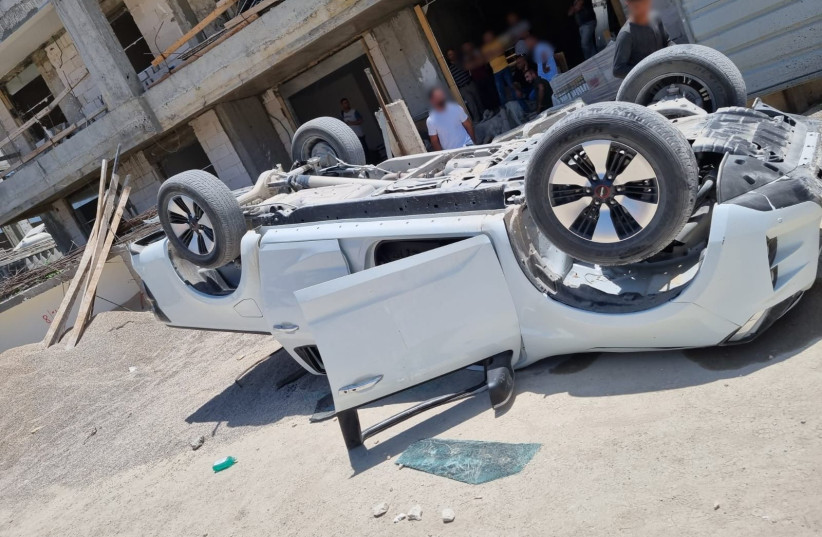  During a fight at a Beit Shemesh construction site, a car was flipped over. (credit: ISRAEL POLICE SPOKESPERSON'S UNIT)