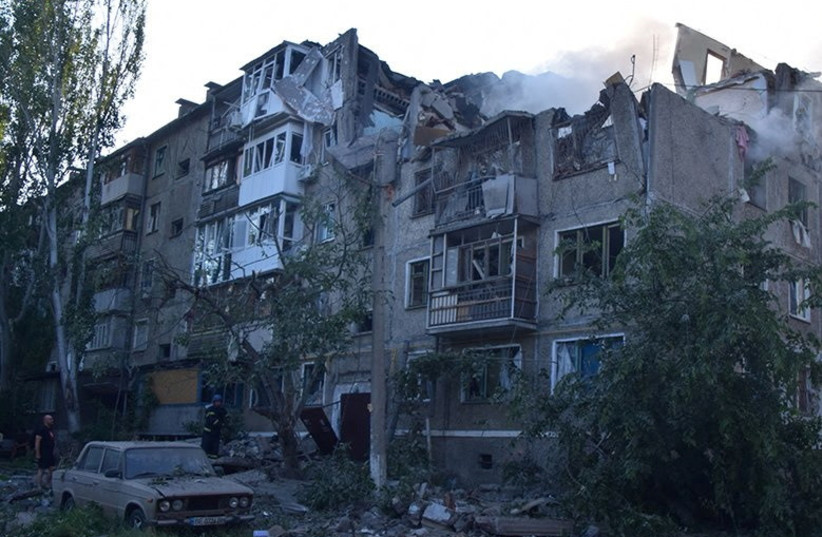  A rescuer stands next to a residential building hit by a Russian military strike, as Russia's attack on Ukraine continues, in Mykolaiv, Ukraine June 29, 2022. (credit: Press service of the State Emergency Service of Ukraine/Handout via REUTERS)