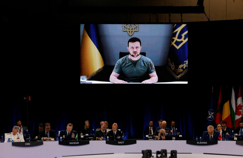  Ukraine's President Volodymyr Zelensky appears on the screen during a NATO summit in Madrid, Spain June 29, 2022. (credit: YVES HERMAN/REUTERS)