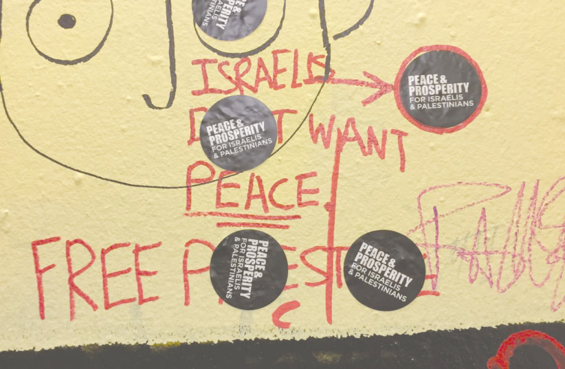 PRO-PEACE stickers placed atop anti-Israel graffiti at the OCAD yellow staircase (photo credit: Jon Jaedon Ziner-Cohen)