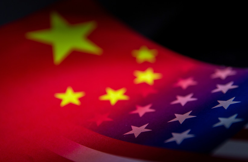 China's and the US' flags are seen printed on paper in this illustration taken January 27, 2022. (photo credit: REUTERS/DADO RUVIC/ILLUSTRATION)