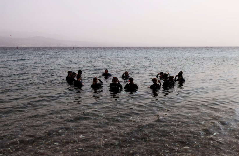  Israeli divers prepare to scuba dive off the Red Sea resort of Eilat on December 12, 2021.  (photo credit: RONEN ZVULUN/REUTERS)
