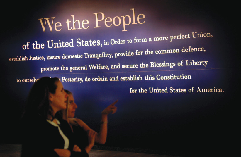  PERUSING a painting of the opening words of the US Constitution, at the National Constitution Center  in Philadelphia, Pennsylvania. (photo credit: William Thomas Cain/Getty Images)
