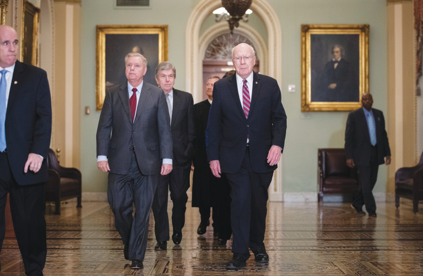  THE VISION of Sen. Lindsey Graham (at L; Republican – South Carolina) was the one that unfortunately materialized into reality.  (photo credit: DREW ANGERER/GETTY IMAGES)